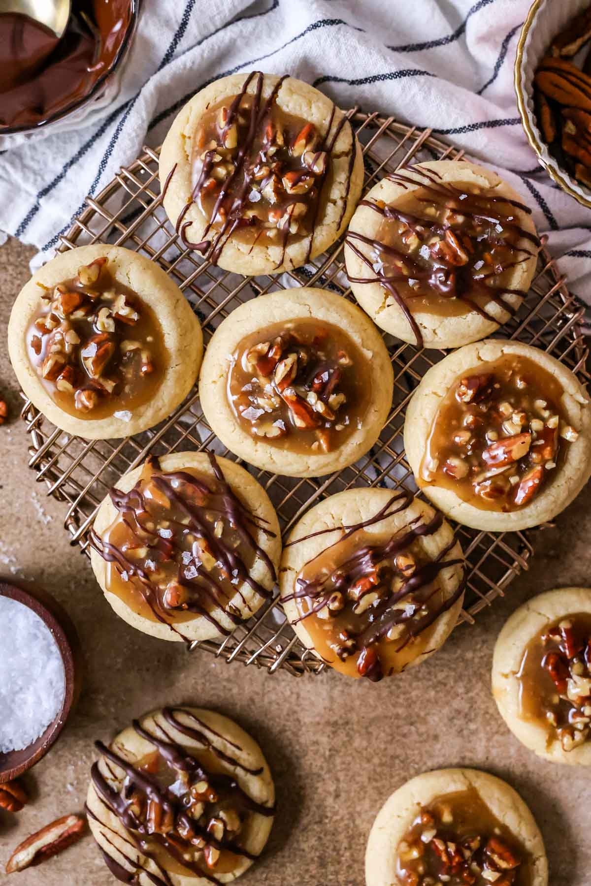 Overhead view of cookies filled with a pecan pie filling and drizzled with melted chocolate.