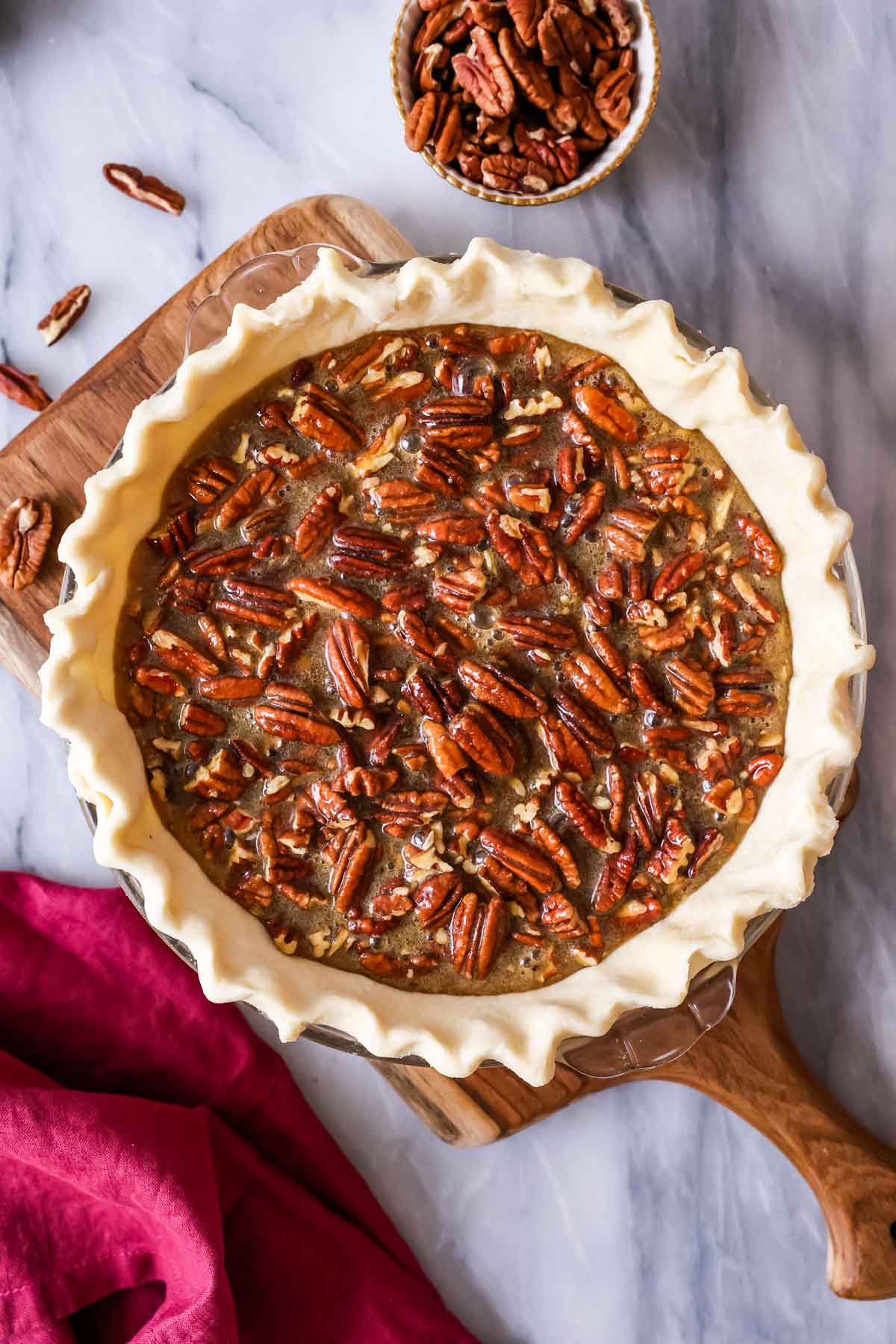 Overhead view of a pecan pie before baking in the oven.