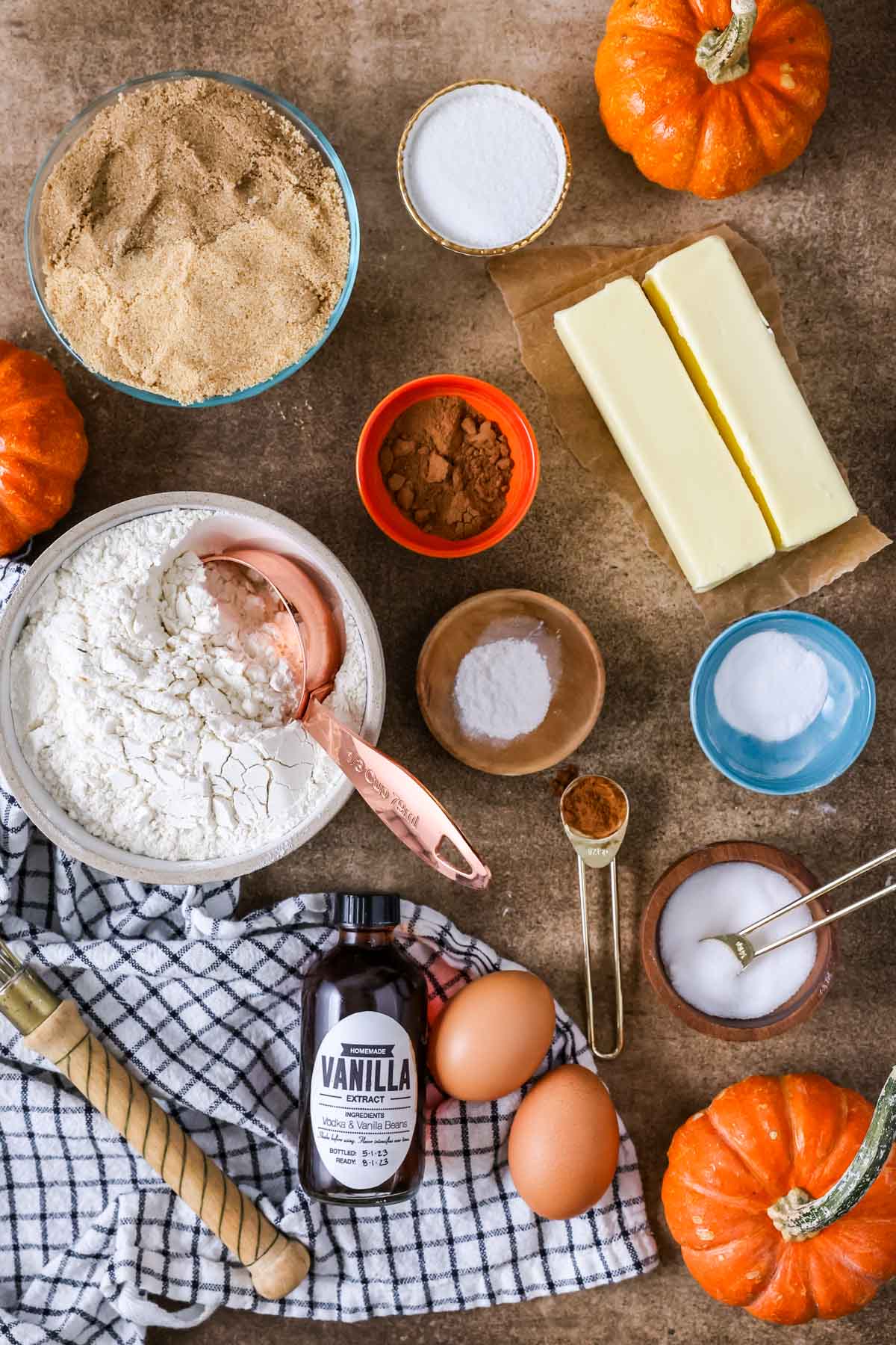 Overhead view of ingredients including flour, brown sugar, pumpkin spice, and more.