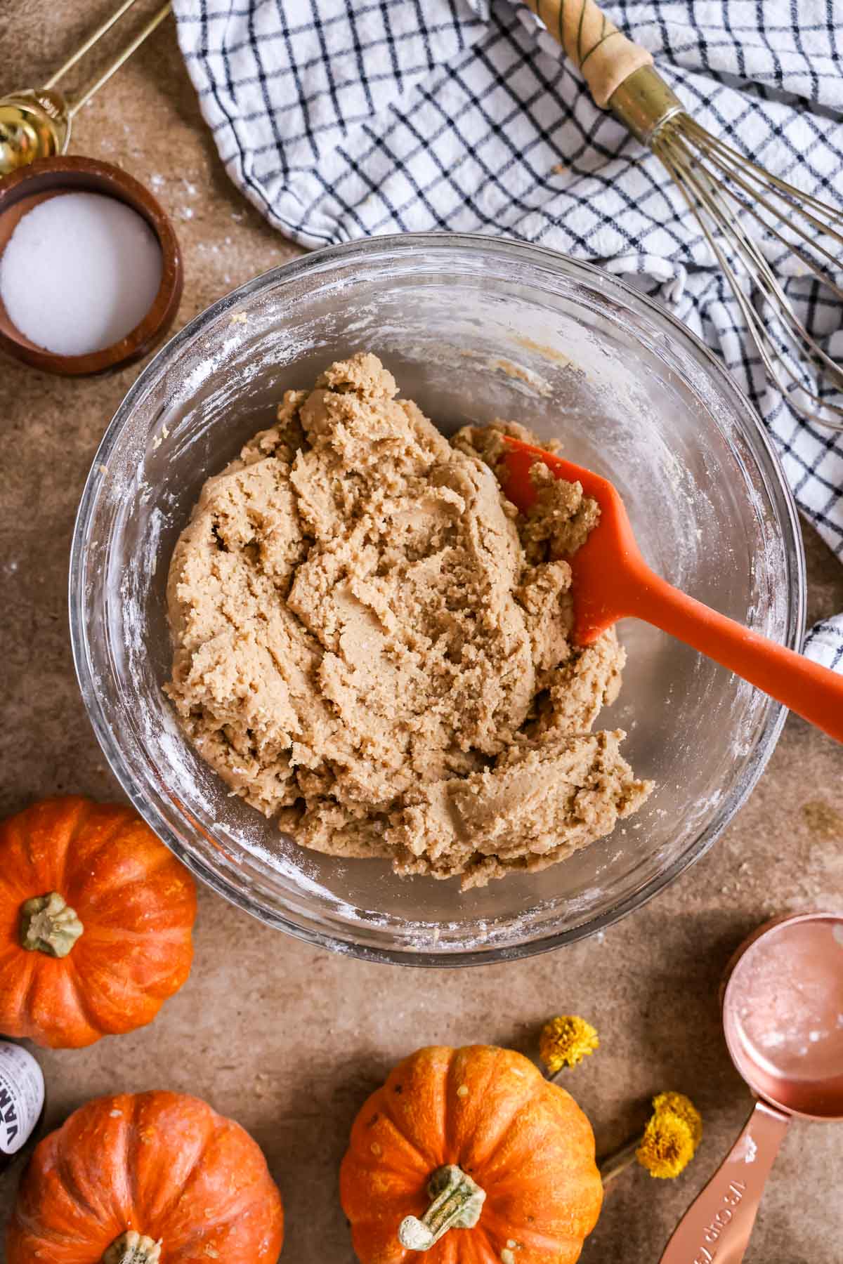 Overhead view of a bowl of cookie dough made with pumpkin spice.