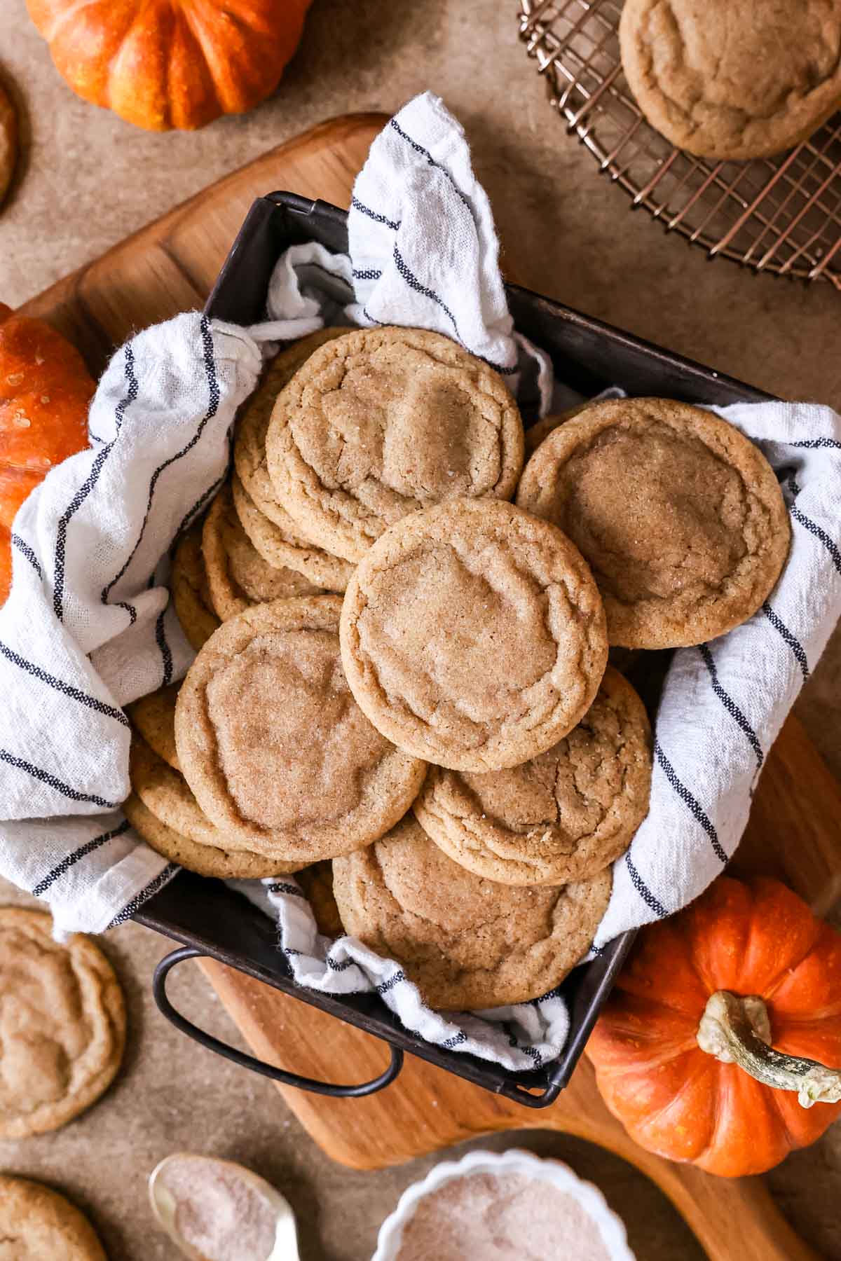 Overhead view of pumpkin spice cookies in a towel lined pan.