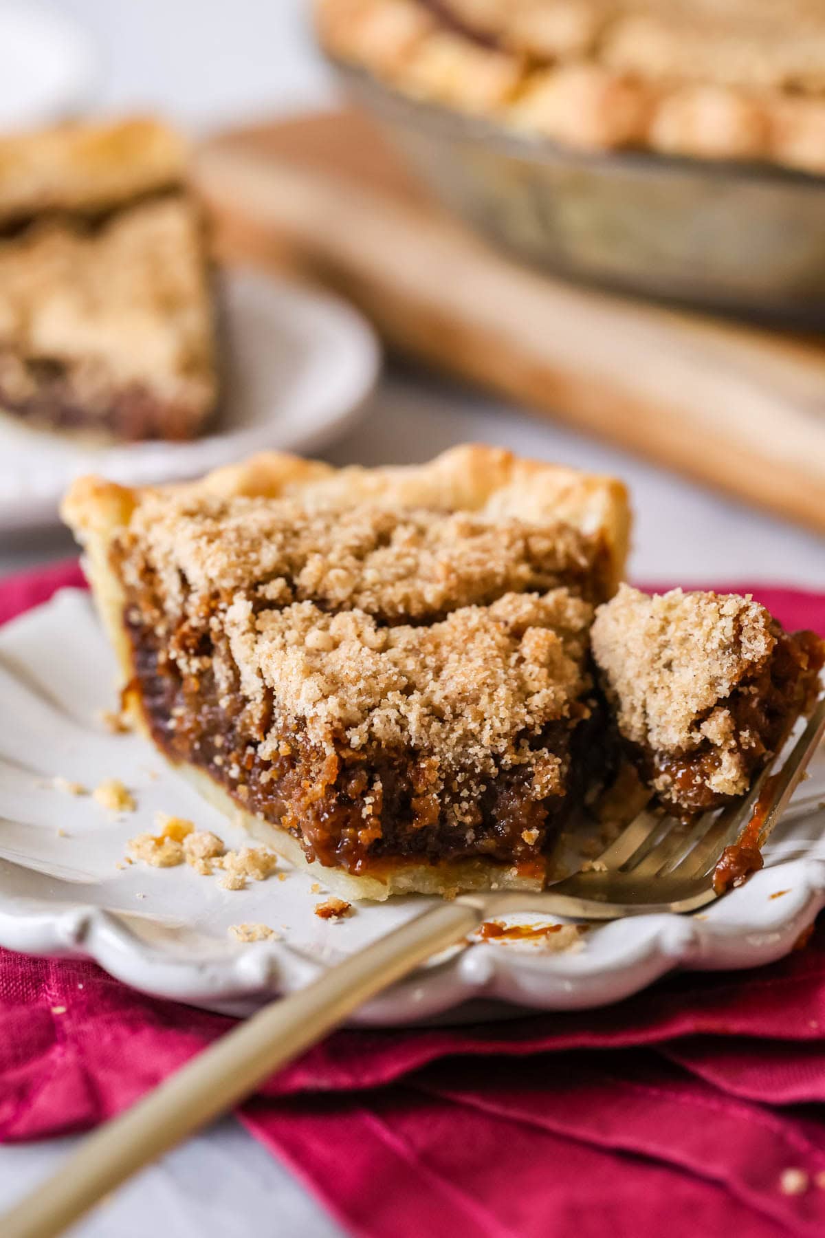 Bite missing from a slice of shoofly pie on a plate.