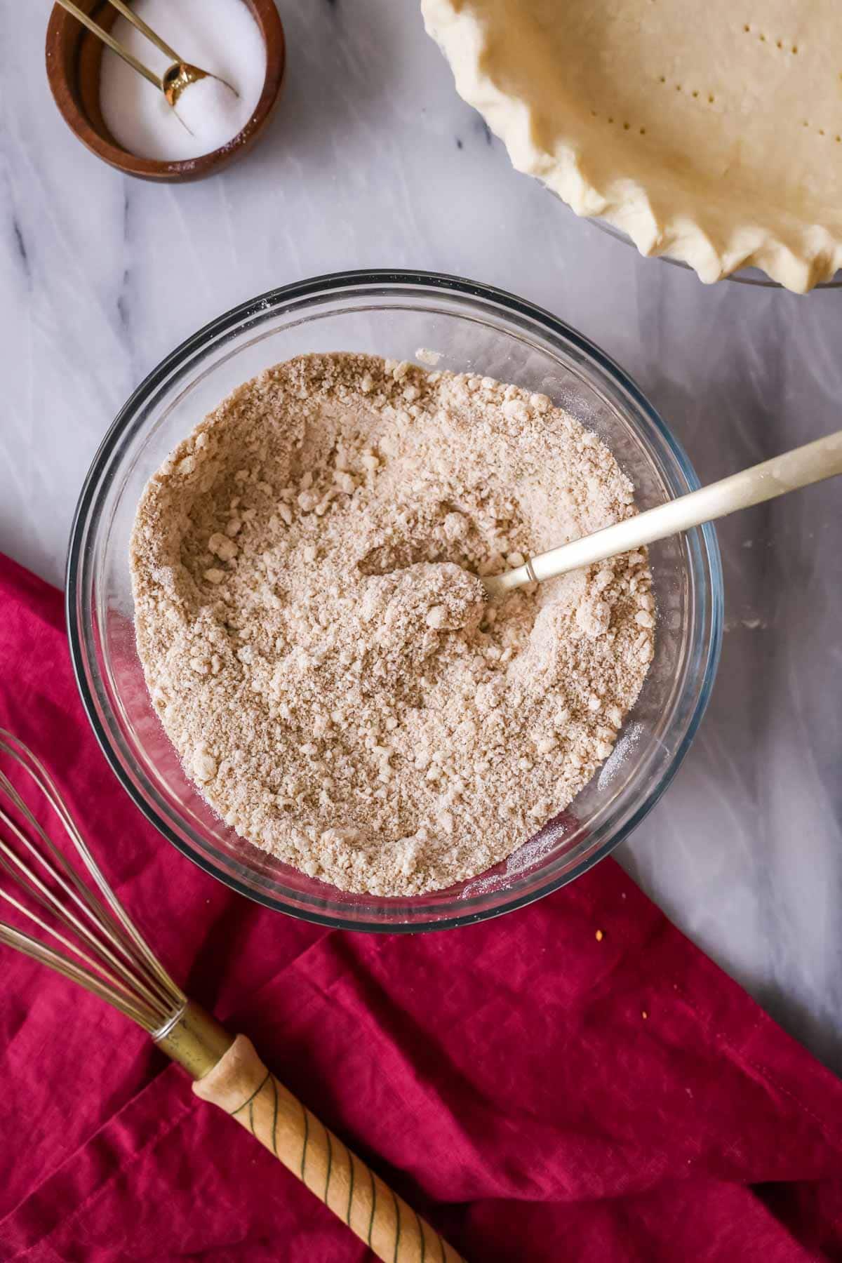 Overhead view of a bowl of a crumbly mixture.