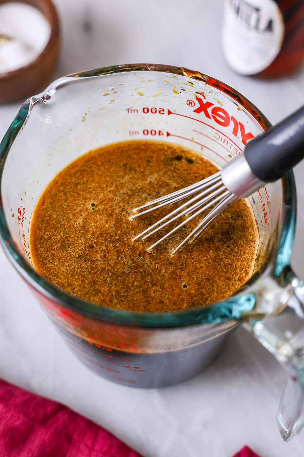 Molasses, hot water, and baking soda combined in a measuring glass.