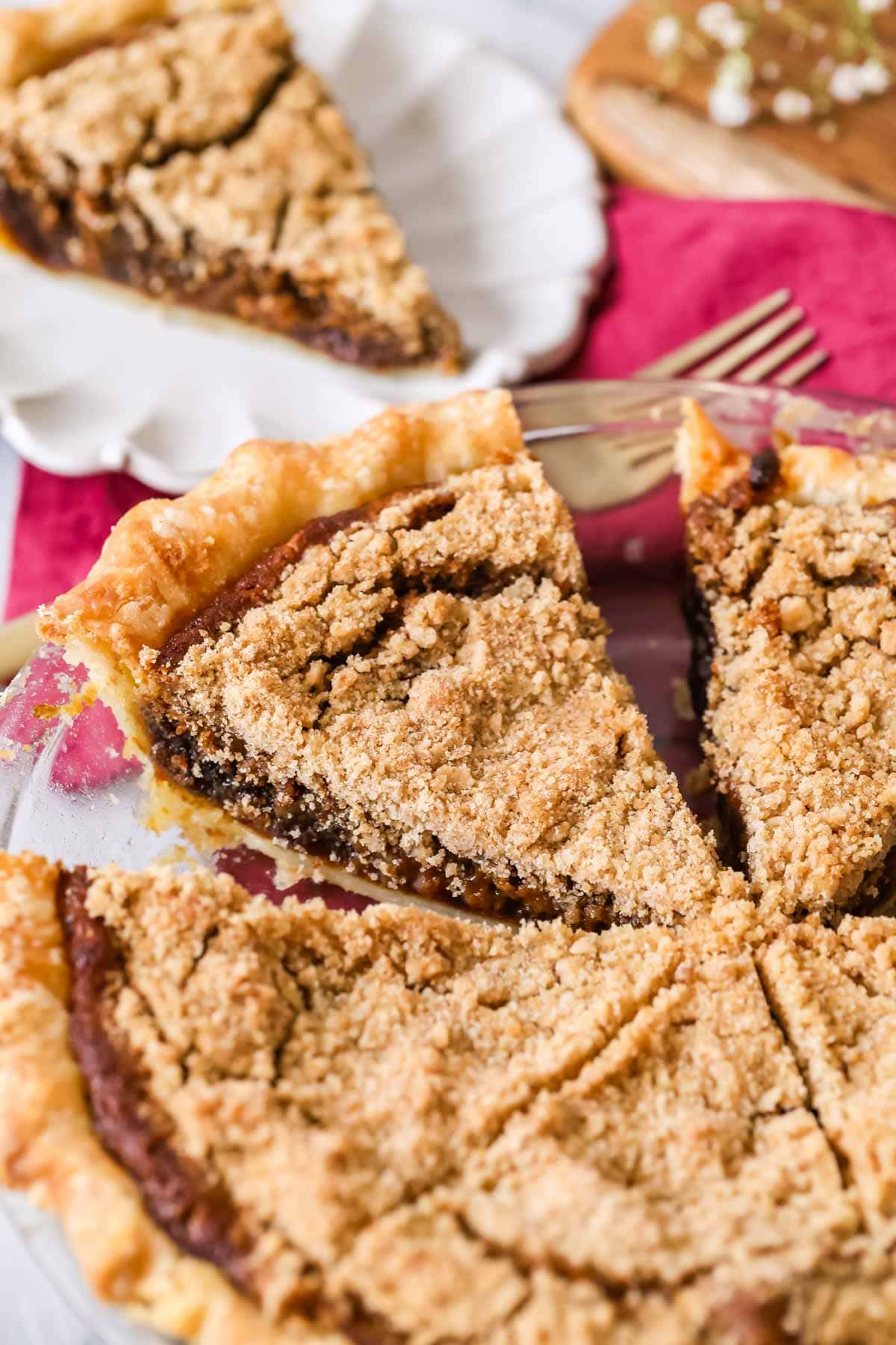 Shoofly pie that's been cut into slices in a pie plate.