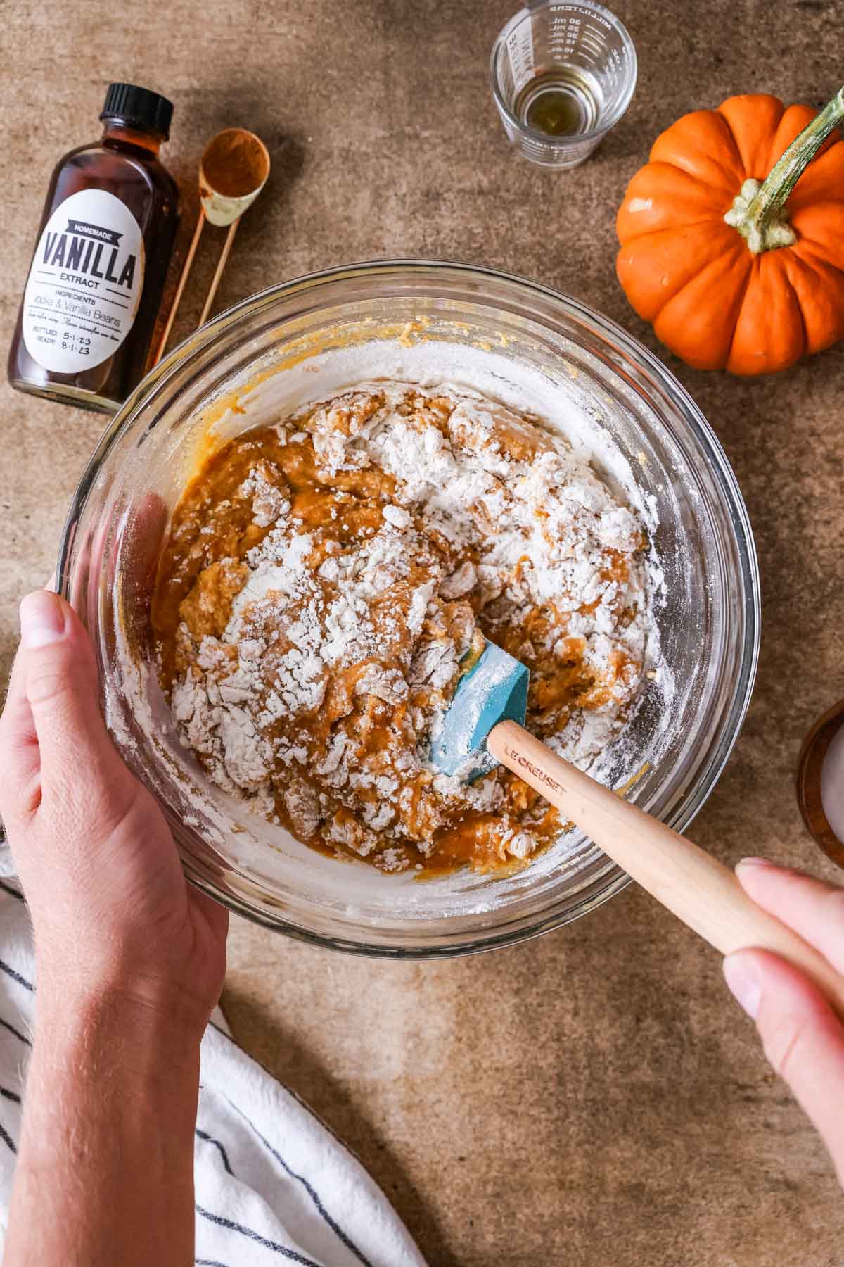 Overhead view of dry ingredients being folded into a muffin batter.