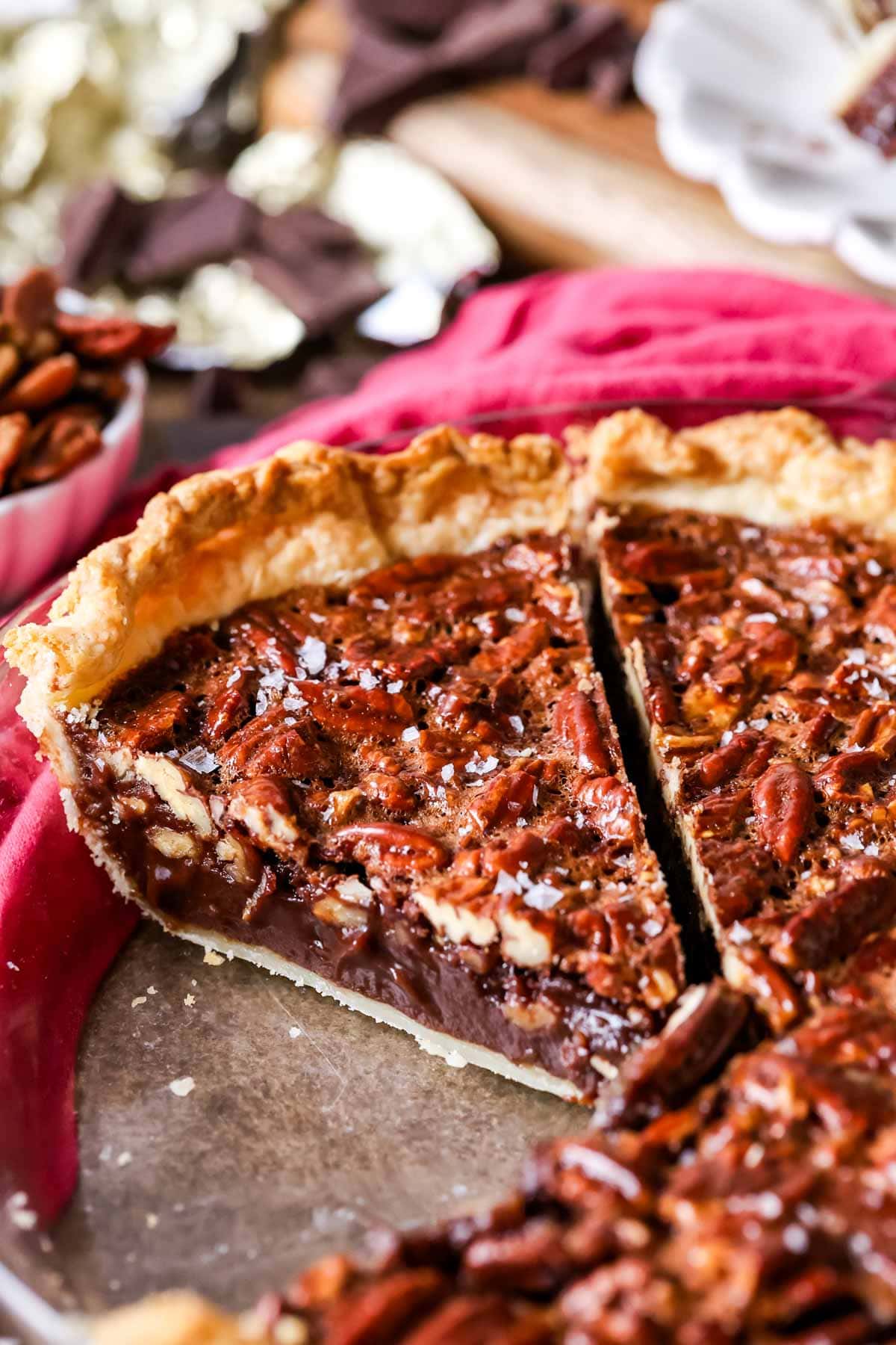 Slices of chocolate pecan pie in a pie plate.