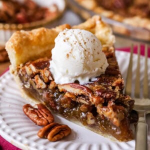 Slice of pecan pie with ice cream on top.